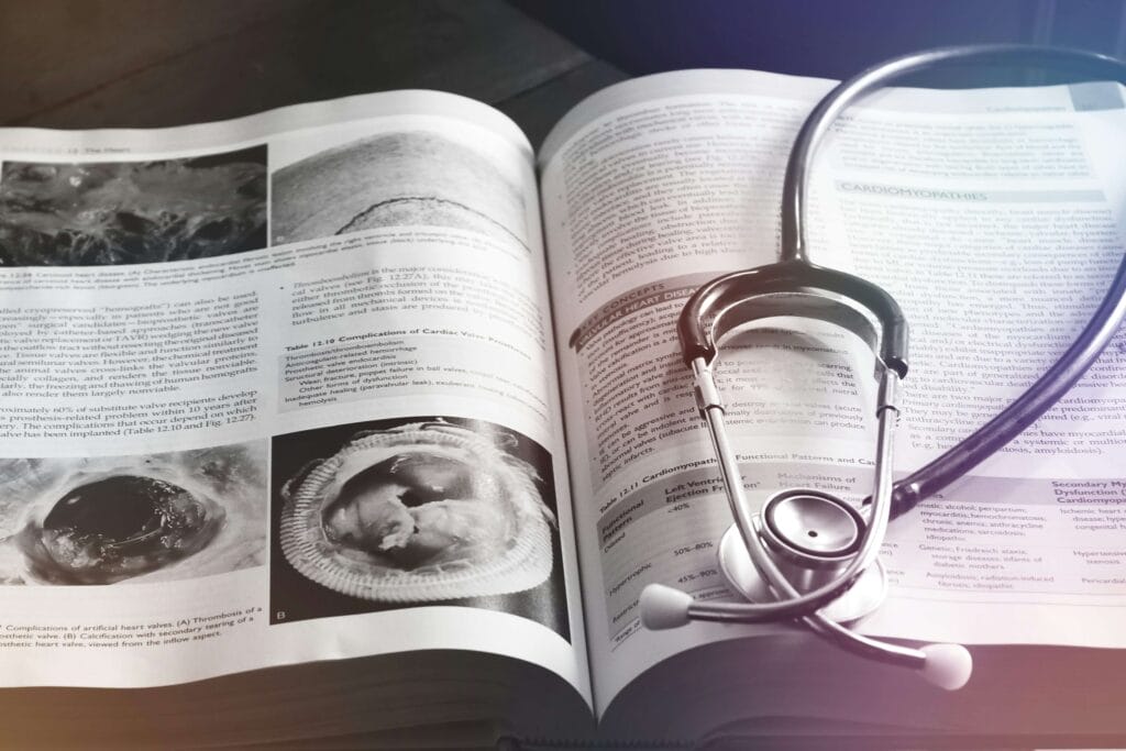 An open book with a stethoscope on it.